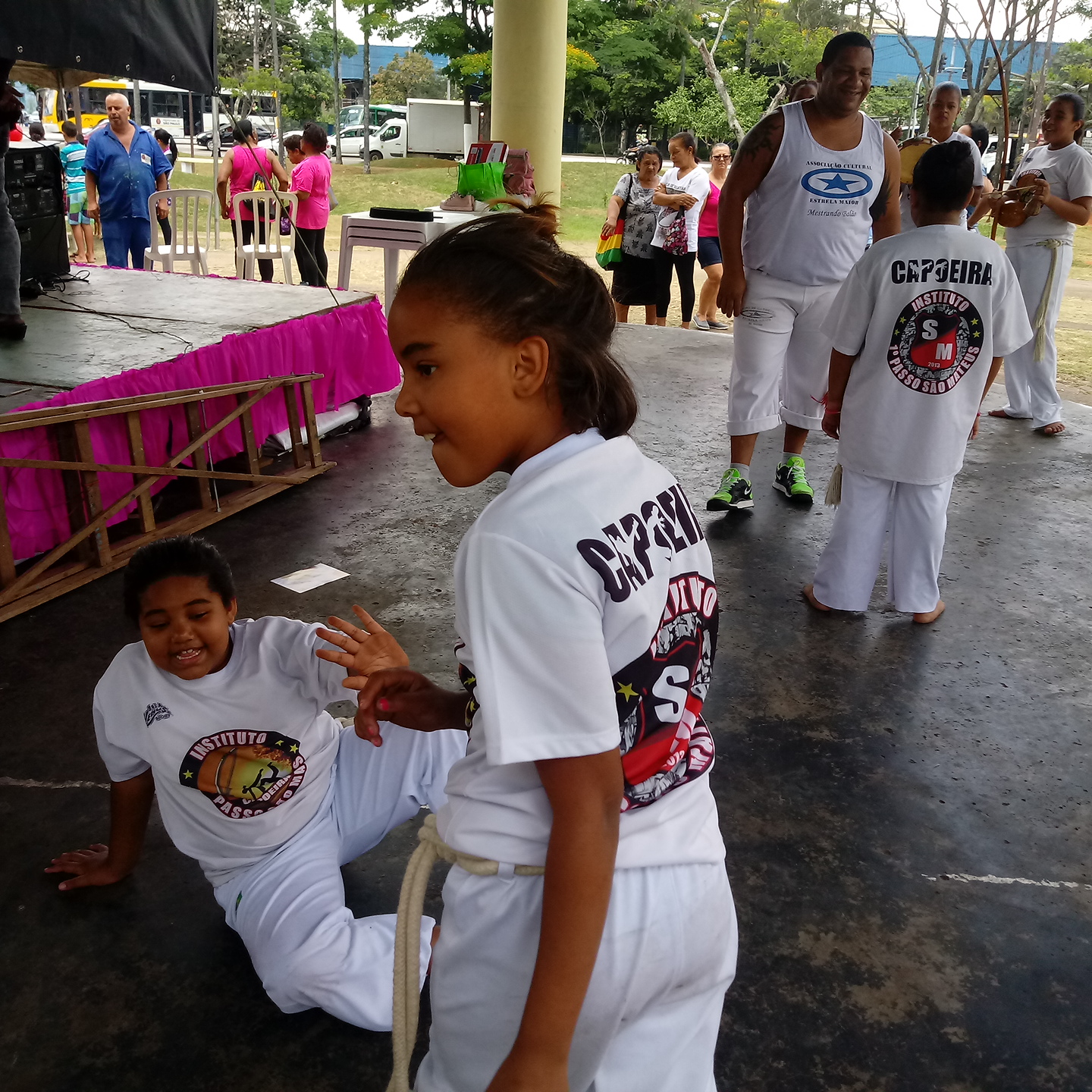 Crianças fazem apresentação de capoeira.