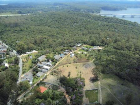 #PraCegoVer - Vista aérea do Parque Bororé, com casas e muita vegetação. Ao fundo, o Rodoanel.