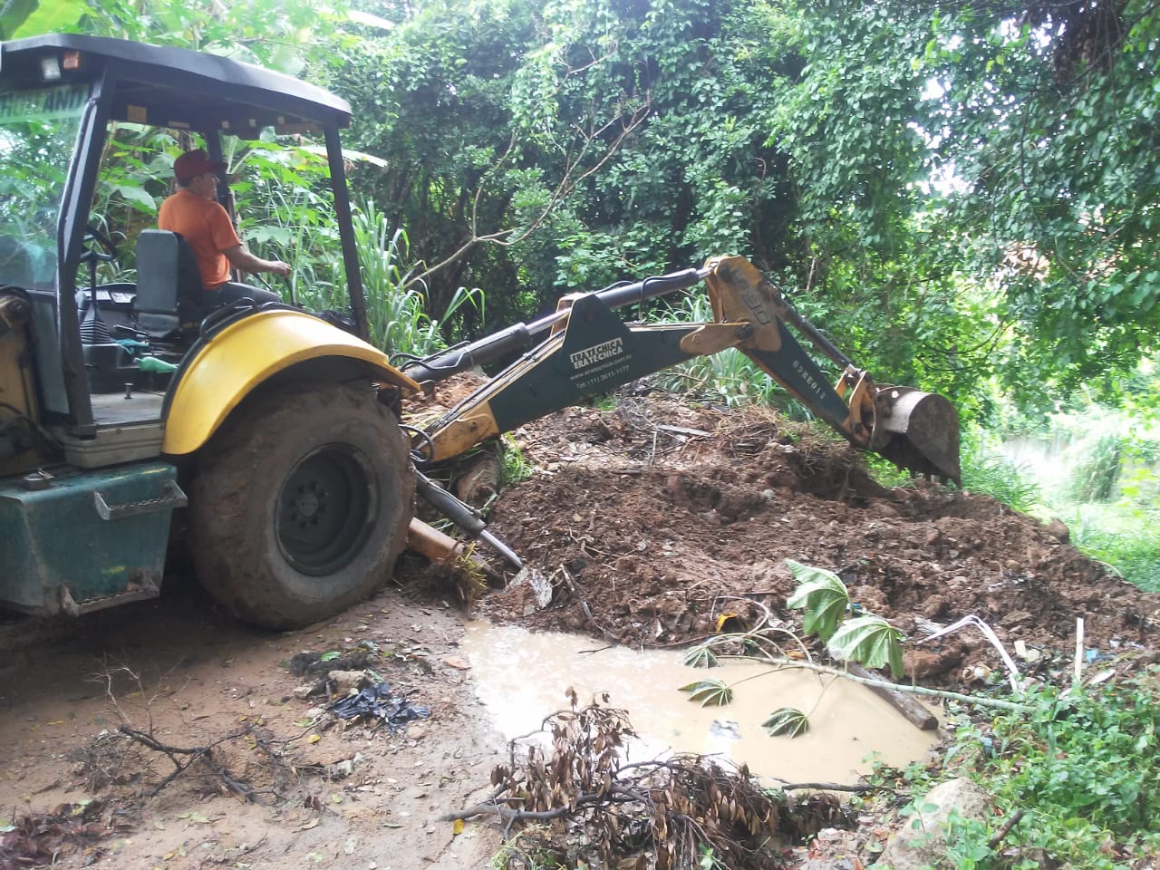 #PraCegoVer - Escavadeira da Subprefeitura faz movimentação de terra para regularizar o terreno da via.