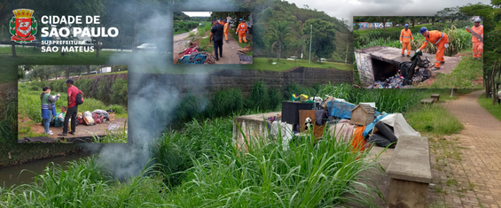 Na imagem vemos uma área verde, é a beira do córrego Aricanduva, há uma estrutura com entulhos e lixo acumulados, ao lado, uma fumaça indicando queima de fios.