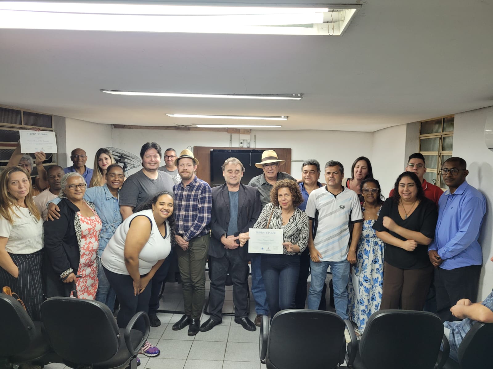 grupo de homens e mulheres posando para foto