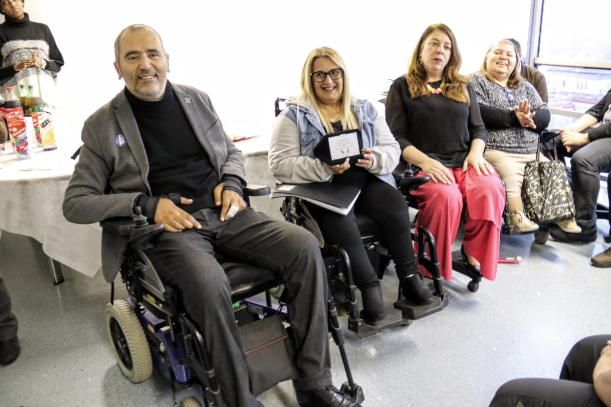  Cid Torquato está ao lado de três mulheres que integram o Conselho da Pessoa com Deficiência. Todos estão sentados em cadeiras de rodas e sorrindo. 