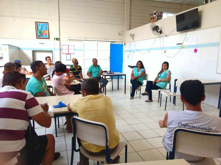 Conviventes conversam em roda na sala de aula 