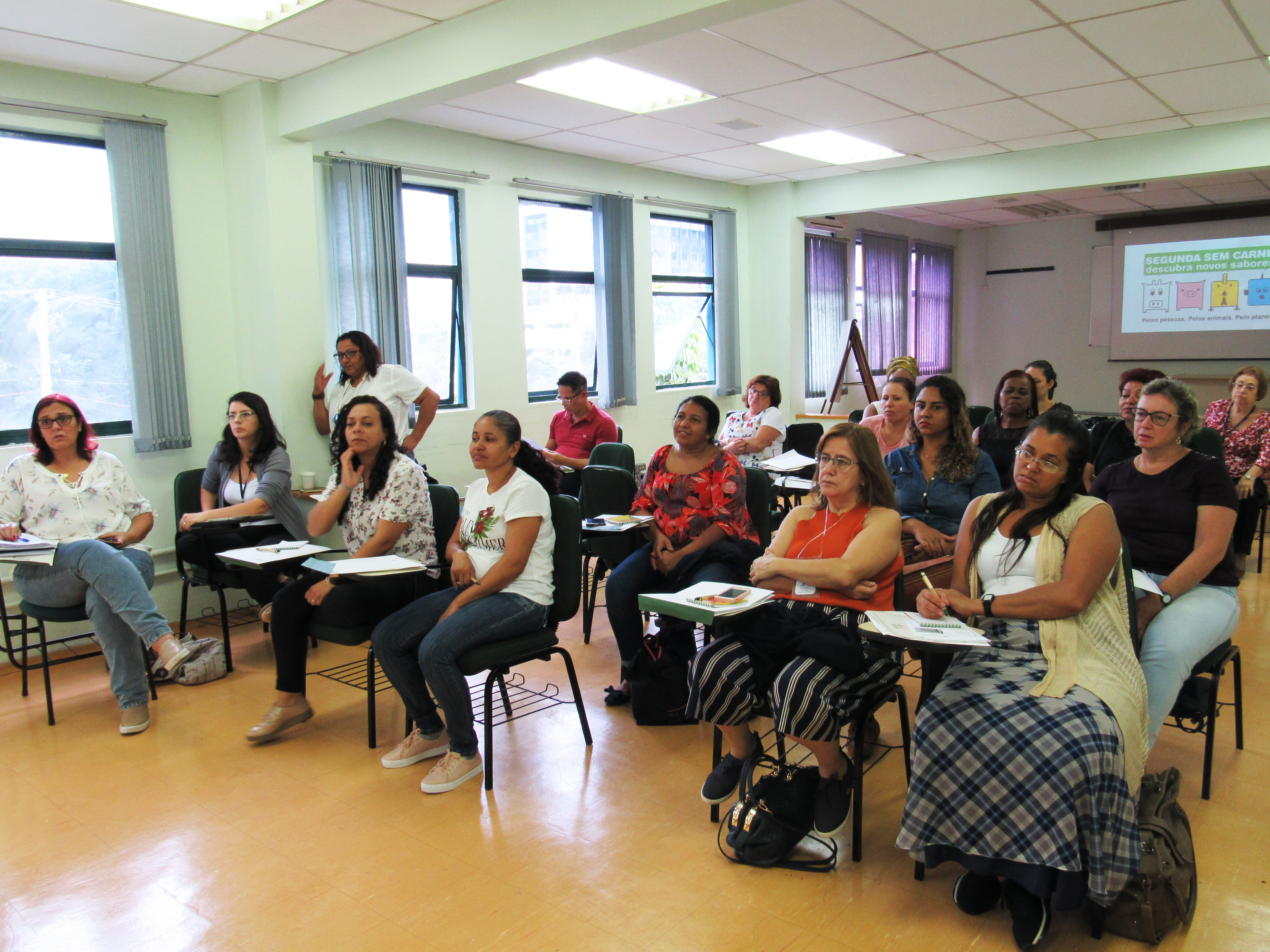 Pessoas presentes no curso do ESPASO sentadas em cadeiras com prancheta de apoio em um total de 17 participantes