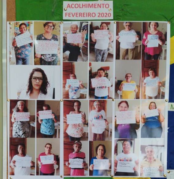Na imagem vemos um mural de fotos de conviventes segurando seus conselhos em uma folha branca.