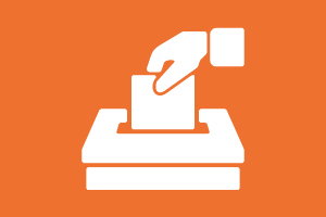 Desenho com fundo cor de laranja com uma mão colocando voto em uma urna