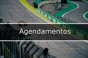 Imagem que mostra pedaço da pista de corrida Interlagos e o carro de corrida passando e no meio  escrito Agendamentos