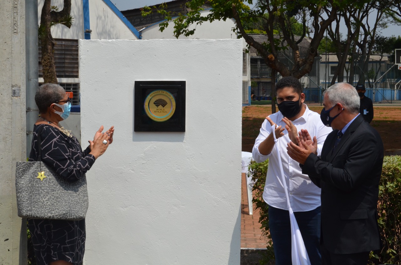 Na imagem, secretário Municipal de Esportes e Lazer, Thiago Milhim junto com a filha do homenageado, Adyel Silva. Logo atrás a Placa homenageando o ex-atleta Adhemar Ferreira da Silva, único atleta brasileiro que está no Hall da Fama da Federação Internacional de Atletismo.