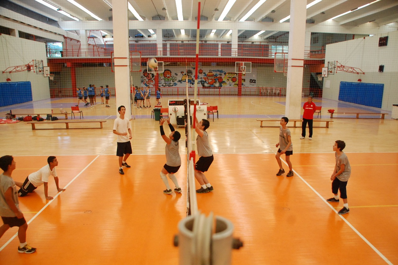 Na imagem atletas de vôlei jogando no ginásio do Centro Olímpico.