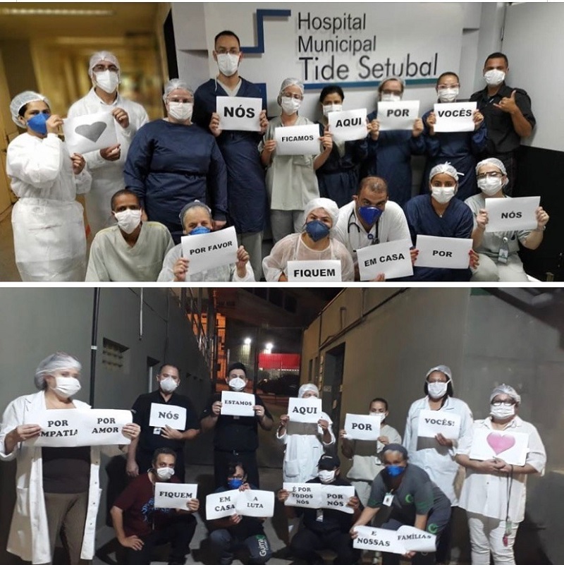  #PraCegoVer: a imagem é uma montagem com duas fotos. A foto da parte superior tem 15 profissionais da saúde com EPI. Cada um está segunrando uma folha de sulfite que juntas formam a frase: Nós ficamos aqui por vocês. Por favor, fiquem em casa por nós. Ao fundo há uma parede com o nome do Hospital Municipal Tide Setúbal. Na fota da parte inferior há mais 11 profissionais com EPI, segundo folhas de sulfite com a frase: Por empatia, por amor, nós estamos aqui por vocês. Fiquem em casa por nós e nossas famílias.