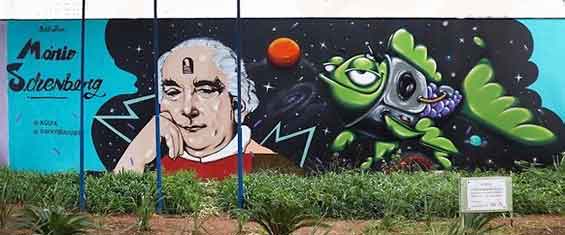 Fachada da biblioteca com uma imagem do patrono Mário Schenberg e um peixe estilizado