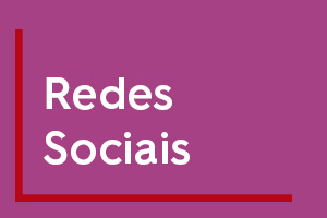 Imagem com fundo roxo com duas linhas vermelhas, uma no canto esquerdo e outra na parte inferior da imagem. No centro escrito em branco a palavra "Redes sociais"